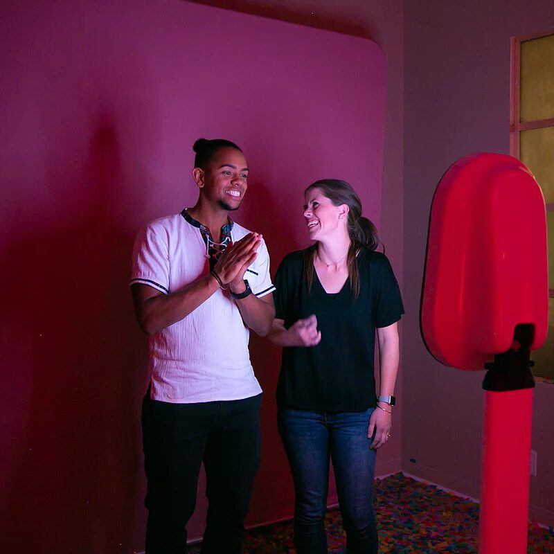 A woman and man standing in front of a photo booth